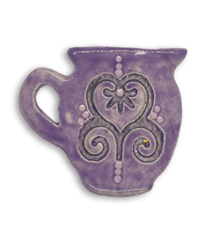 A hand-painted purple jug ceramic mosaic insert with a swirling heart design.