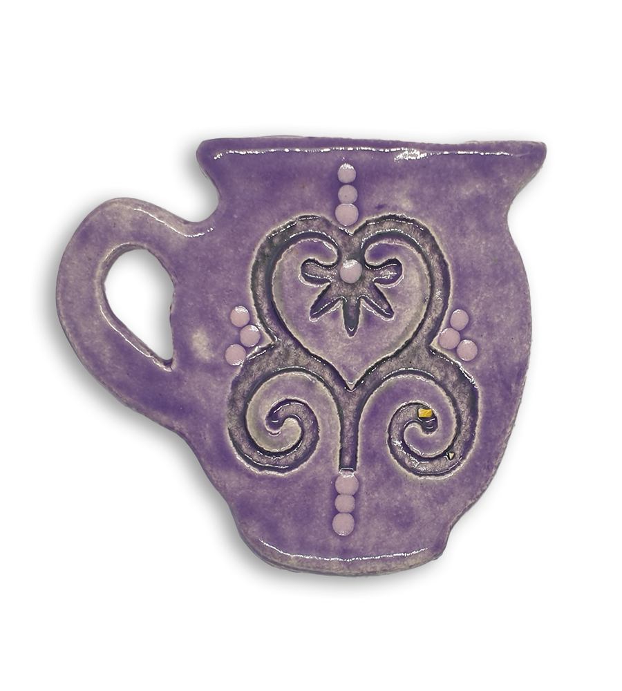 A hand-painted purple jug ceramic mosaic insert with a swirling heart design.