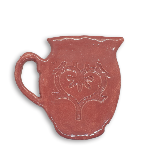 A hand-painted pink jug ceramic mosaic insert with a swirling heart design.