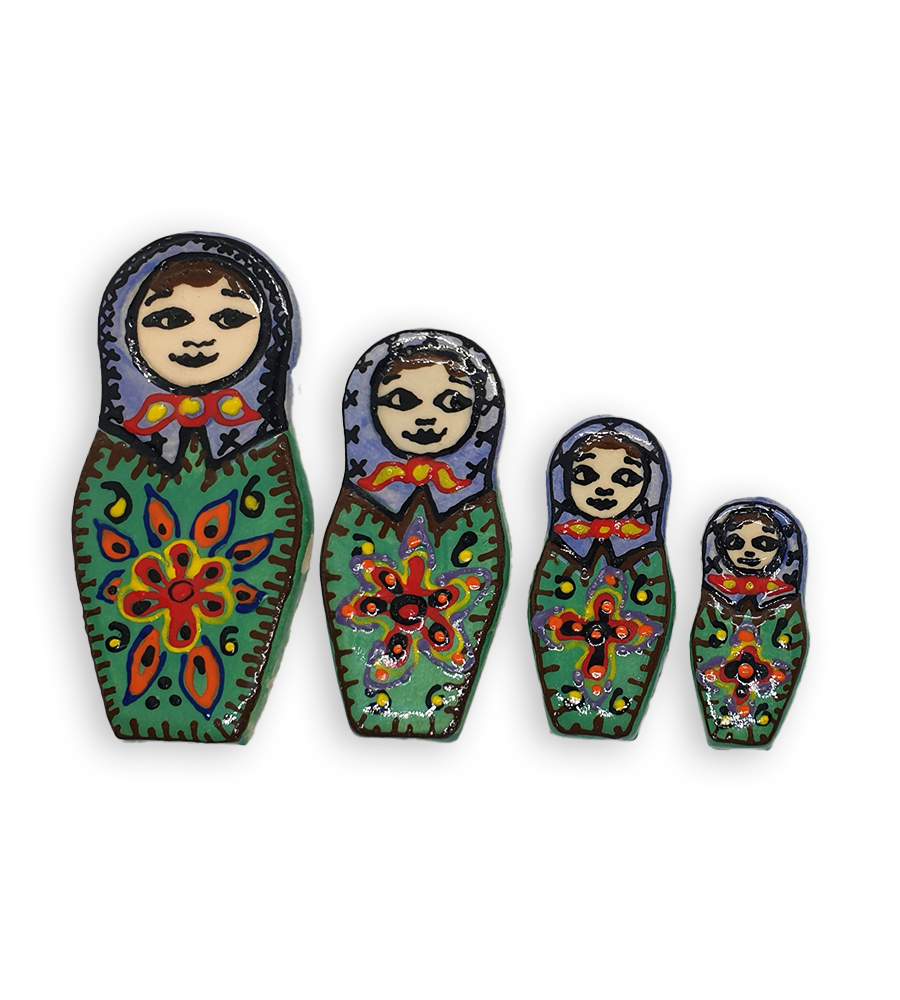 A set of four hand-painted Russian Doll ceramic mosaic inserts with green dresses and purple headscarves, and brown edging.