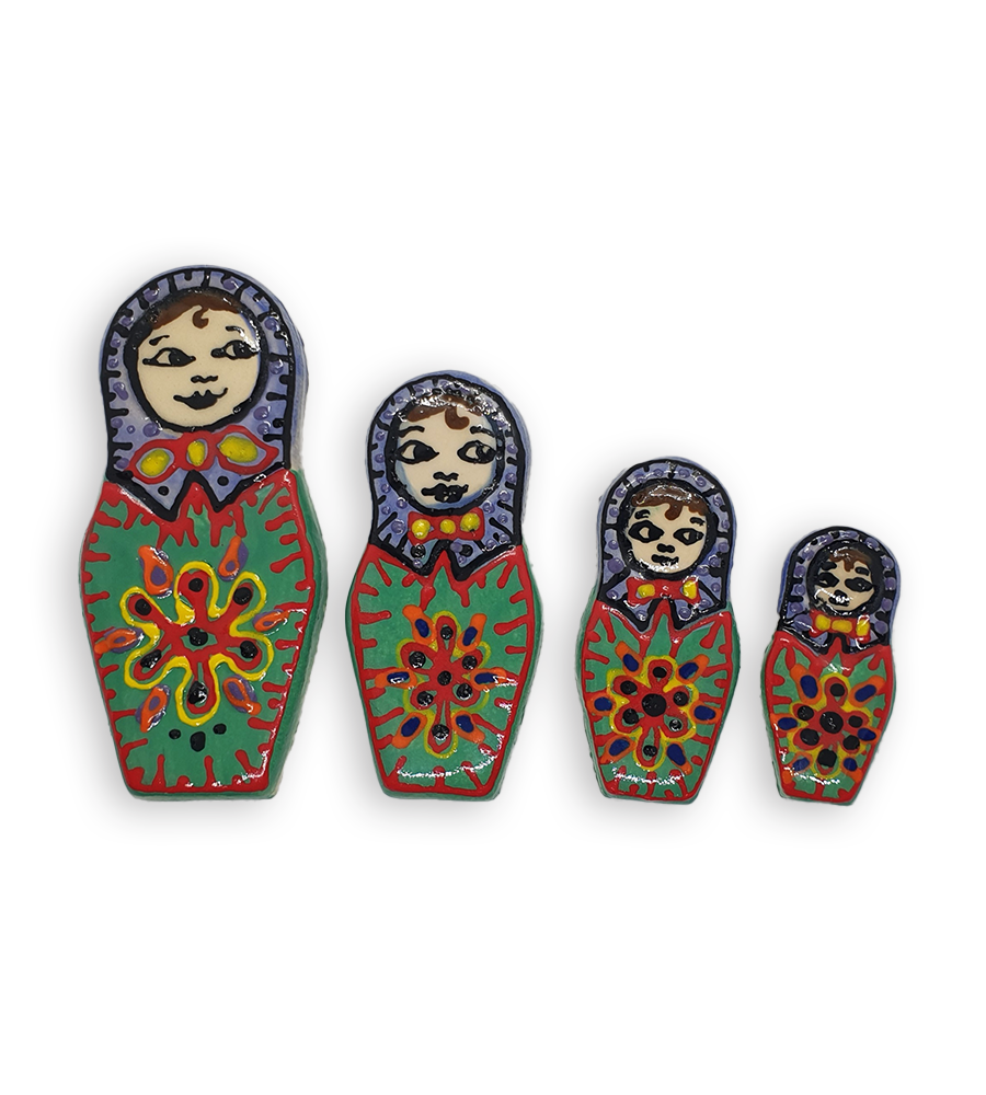 A set of four hand-painted Russian Doll ceramic mosaic inserts with green dresses and purple headscarves, and red edging.