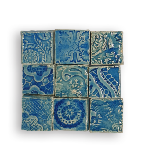 A collection of nine textured square tiles in blue.