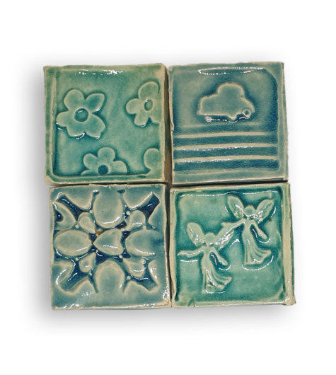 A collection of four textured square tiles in blue-green.