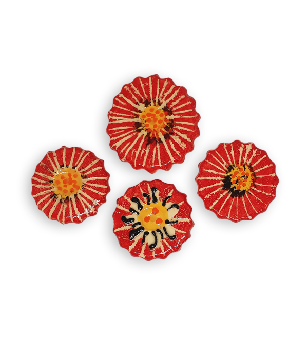 Four ceramic mosaic inserts in the shapes of bright red flowers.