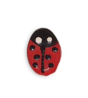 A ceramic mosaic insert in the shape of a ladybug.