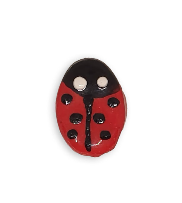 A ceramic mosaic insert in the shape of a ladybug.